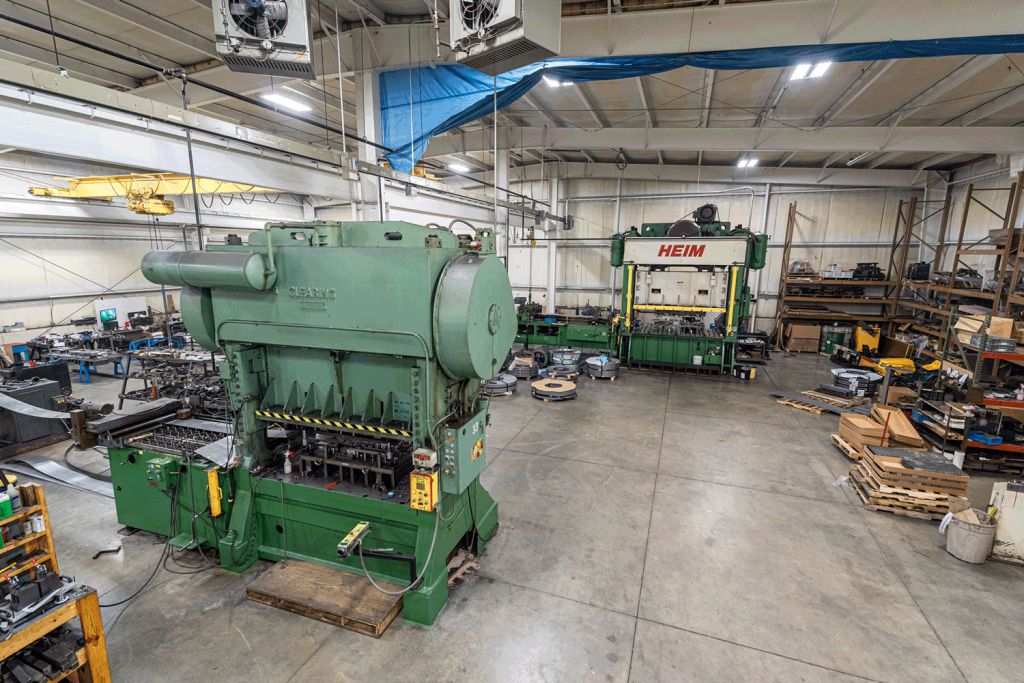 A view of two parts stamping presses surrounded by pallets.