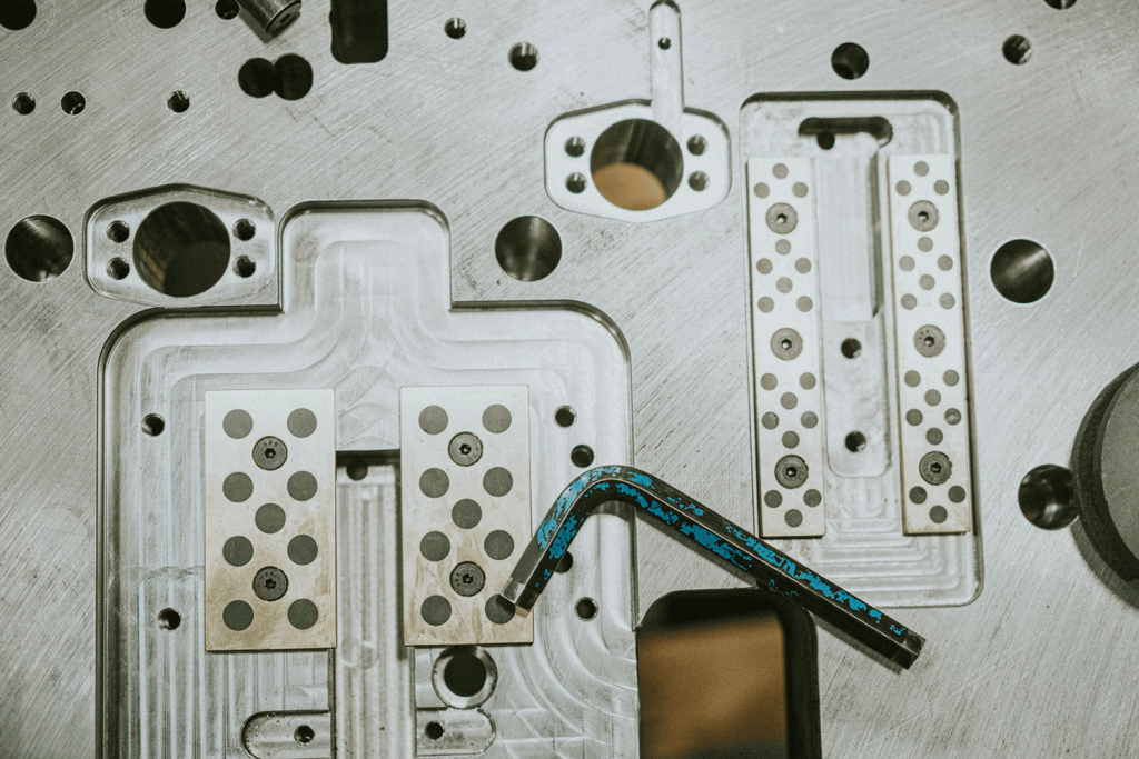 Allen wrench laying on top of a stamping die.