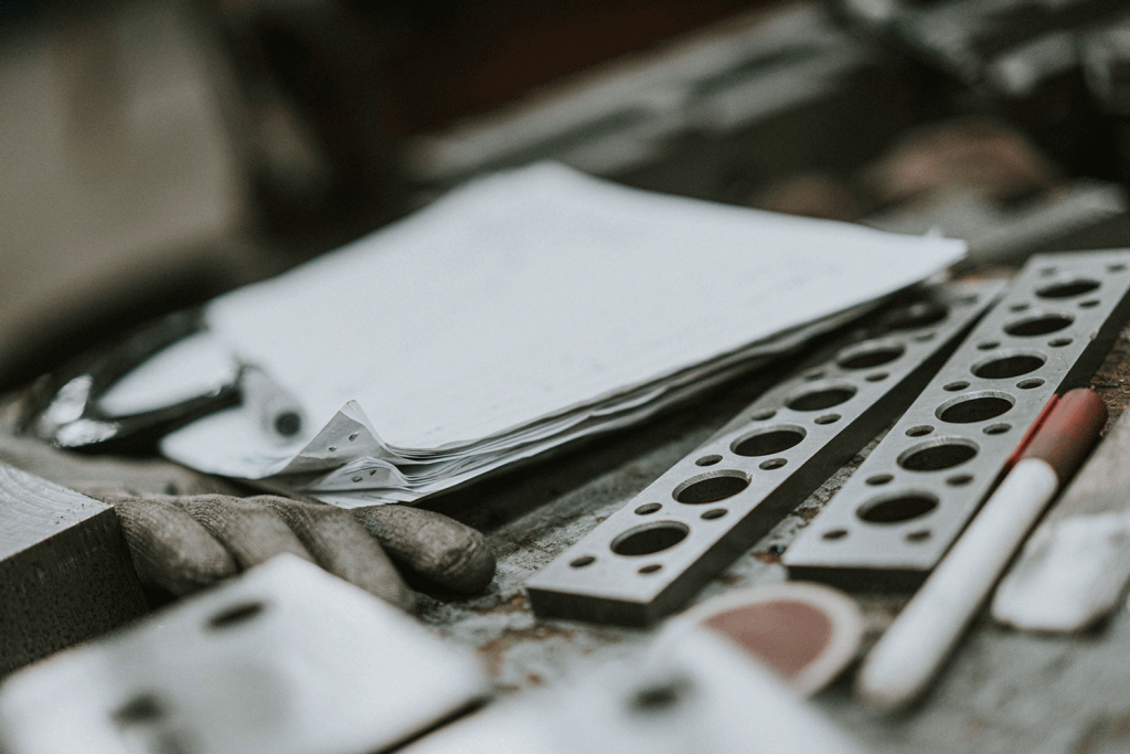 A table displaying various tools and a sheet of paper placed on top.