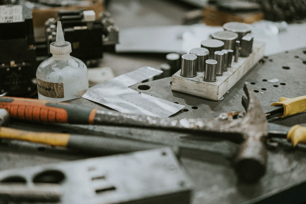 Another table displaying hammers, solvents and other die making tools.
