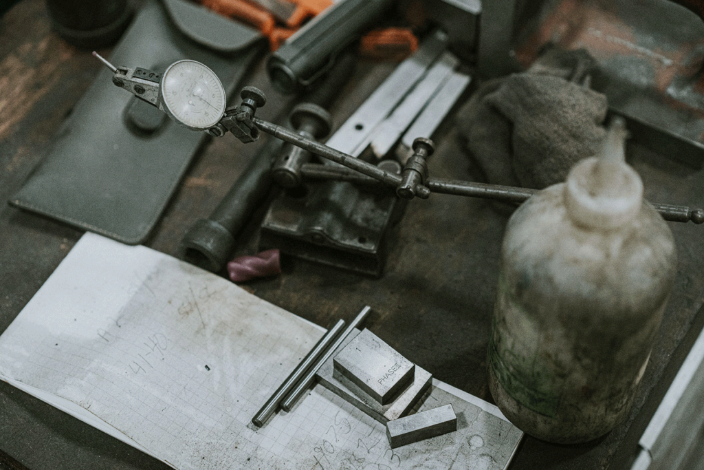 Overhead view of a pressure gauge, solvent and an oily rag.